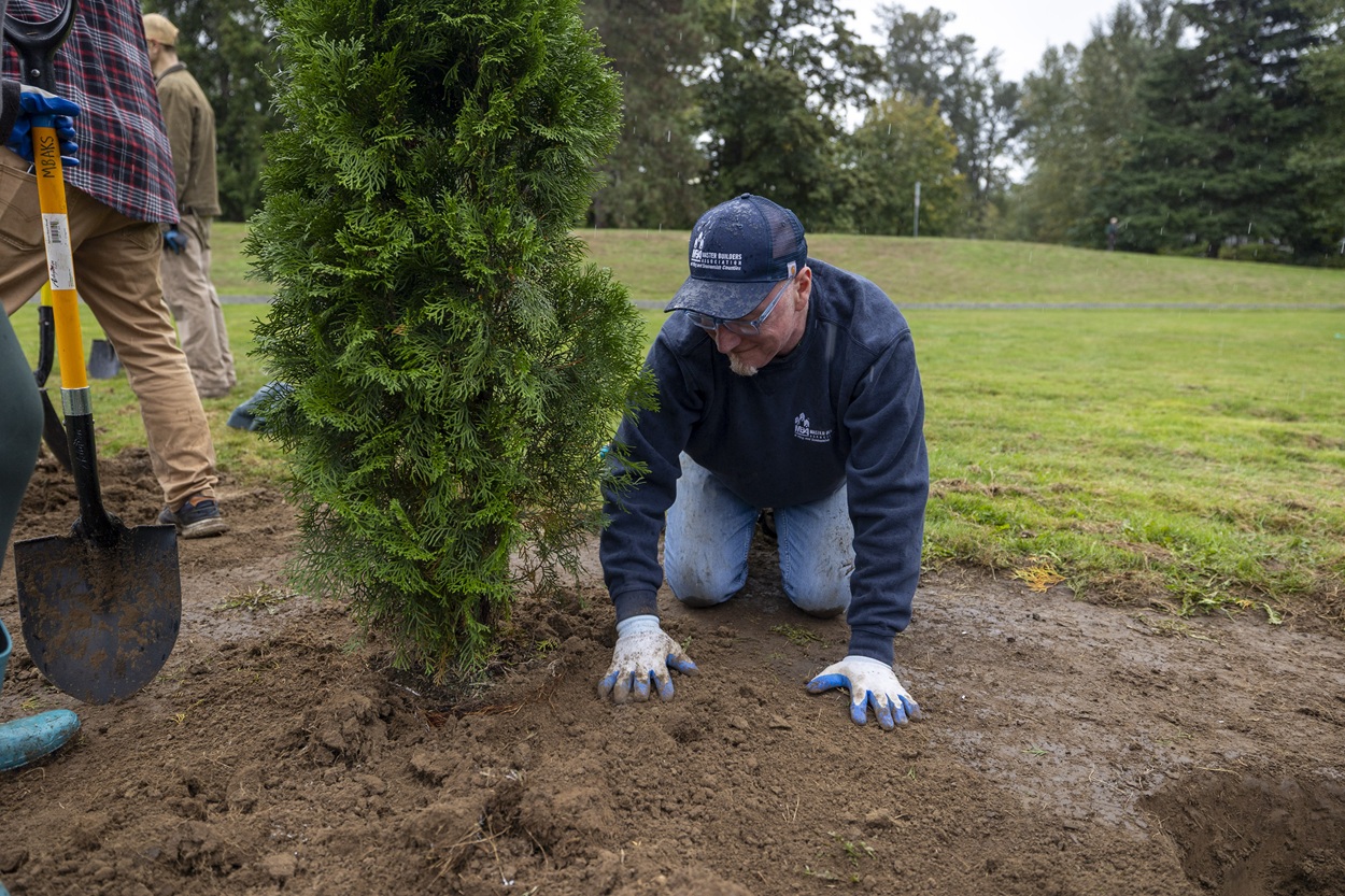 MBAKS volunteer planting a tree