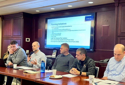 A group presenting from a table.