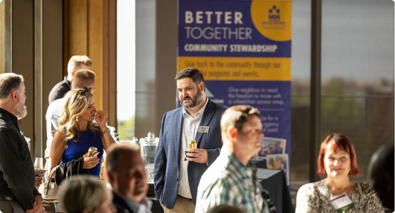 People conversing in a well lit conference room.