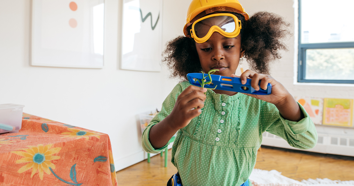 Young girl with construction hat playing