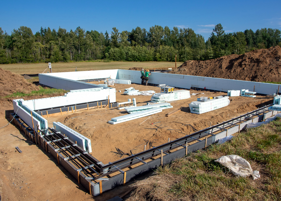 TC Legend Everson Net-Positive home under construction—slab-edge stem walls encased in foam insulated concrete forms (ICF), photo credit Zigzag Mountain Art