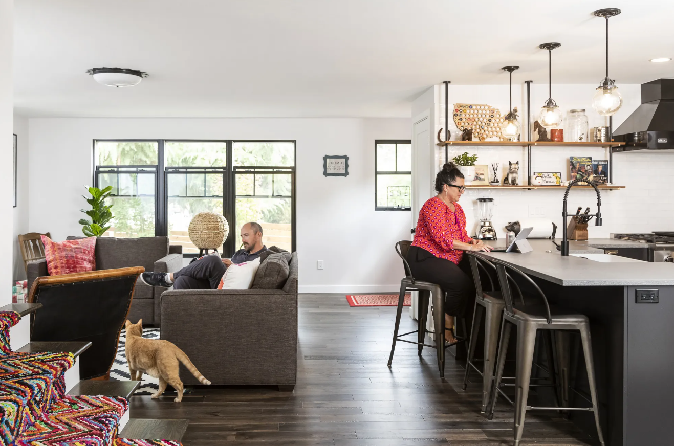 Couple enjoying their living space with cat