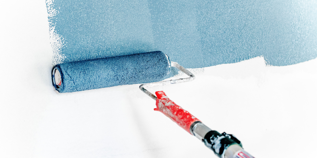 Painting a white wall blue with a paint roller